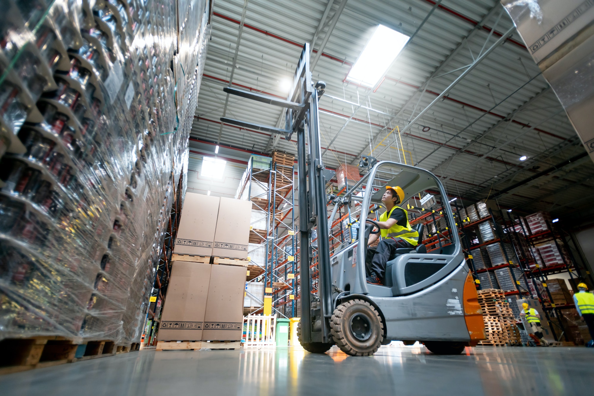 Warehouse worker operates a forklift